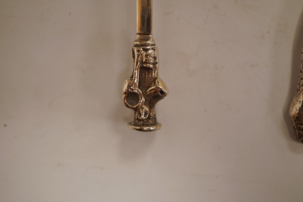 An 18th century silver apostle spoon, indistinct marks, 17cm, a continental white metal spoon with scroll handle and a pair of unmarked white metal spoons with serpent handles.